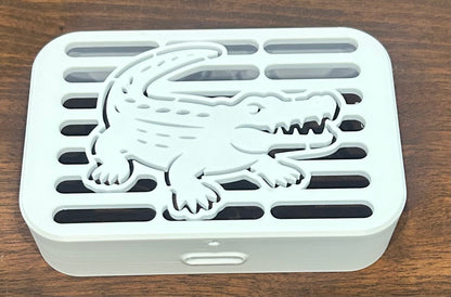 Close-up of alligator gutter cover showing scale detail and water opening, Coastal Spouts design.