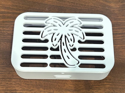 Detailed view of palm tree downspout cover with frond design and water outlet, Coastal Spouts handcrafted piece