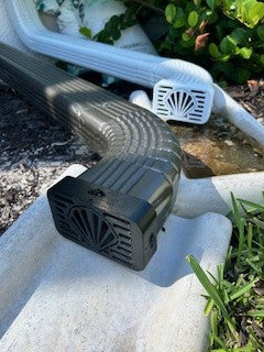 Shell-shaped decorative downspout cover for beach homes, coastal gutter cap featuring seashell design from Coastal Spouts.